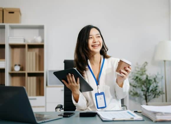 Two minutes of exercise can reduce cancer risk by 20% Asian Businesswoman Analyzing Finance on Tablet and Laptop at modern Office Desk
