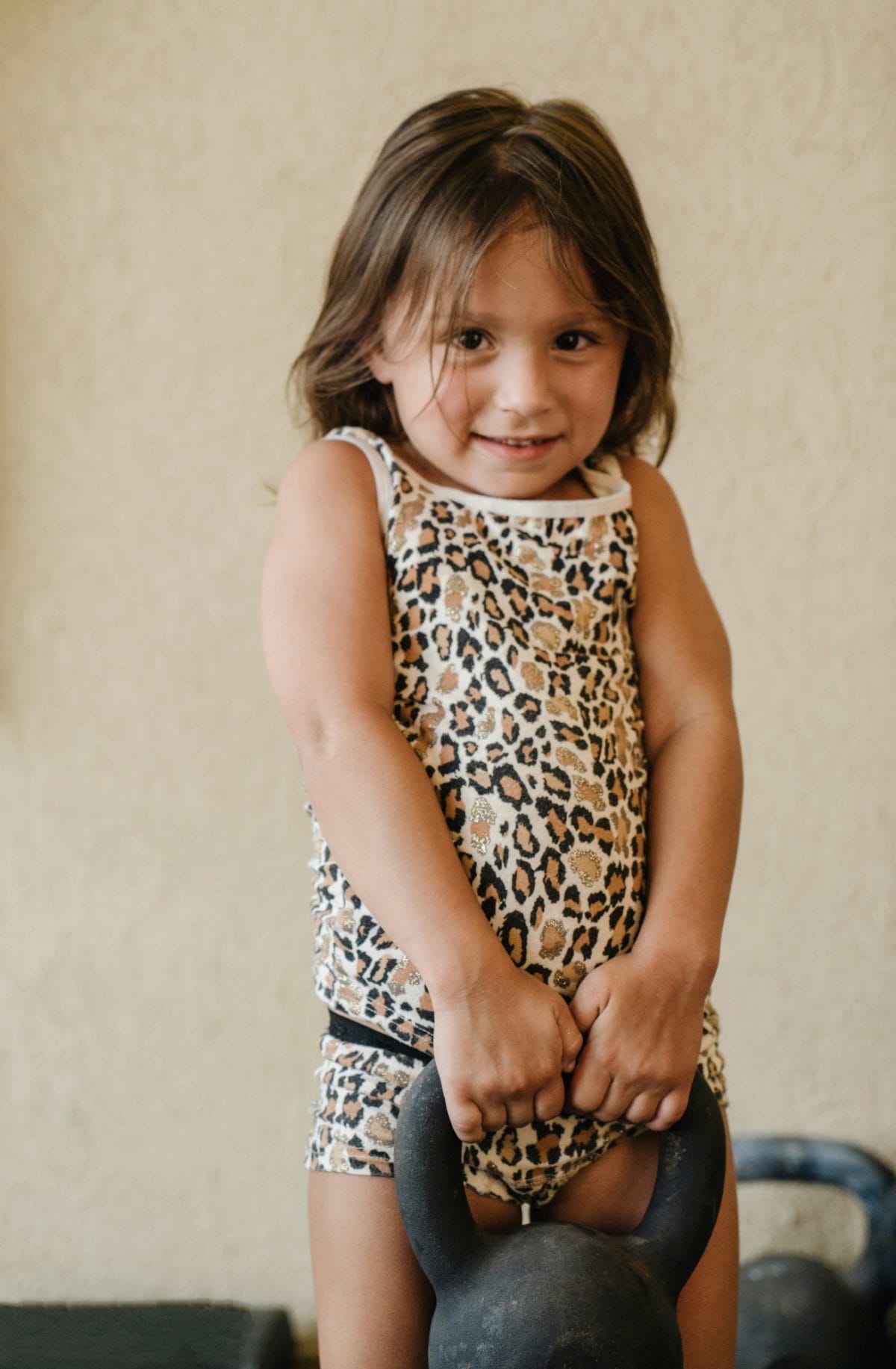 Beefed-up muscles leads to beefed up grades, test scores for kids and teens Strong girl lifting weights